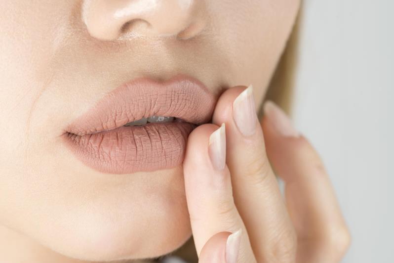 Девушка касается губ