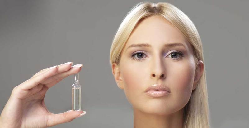 Девушка держит алоэ в ампулах для лица